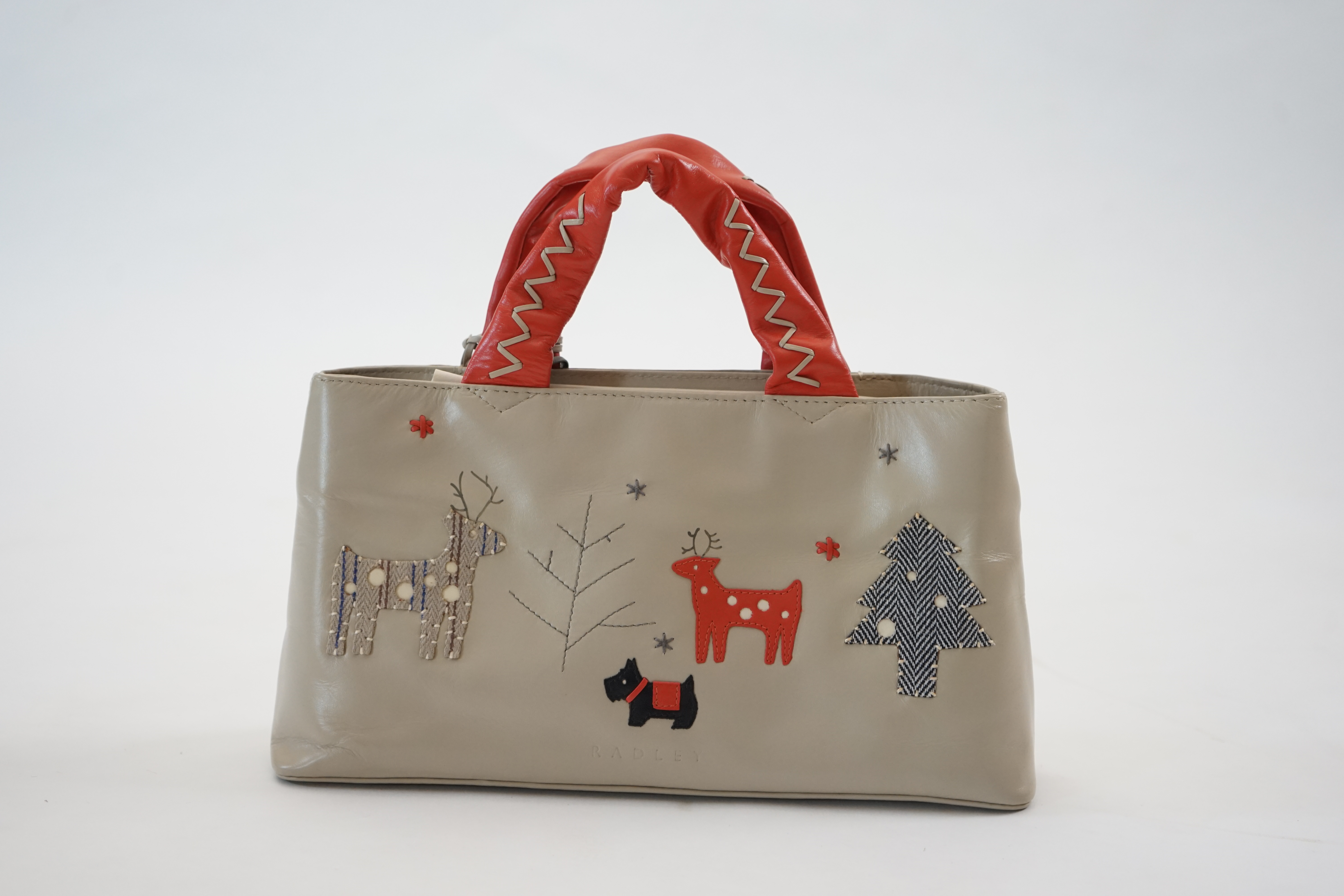 A Radley 'Seasons Greeting Reindeer Christmas' leather grab handle bag 2005, width 30cm, depth 8cm, height 16cm